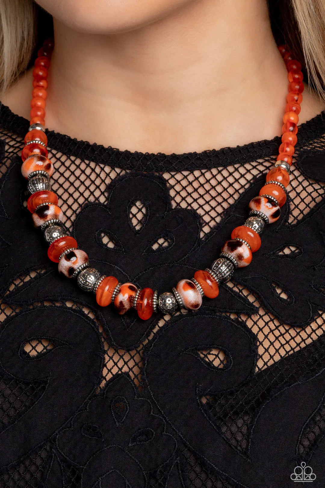 Paparazzi Accessories Warped Whimsicality - Orange An earthy collection of dotted silver beads, rounded milky orange beads, studded silver rings, orange-spotted ceramic-like beads and textured silver beads are threaded along an invisible wire below the co