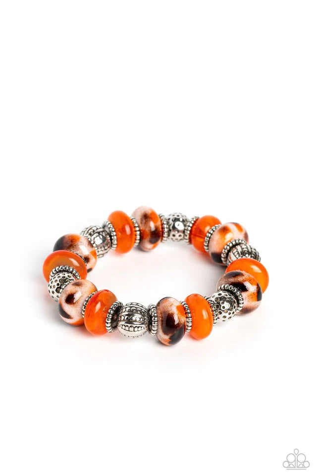 Paparazzi Accessories Warped Wayfarer - Orange An earthy collection of dotted silver beads, rounded milky orange beads, studded silver rings, orange-spotted ceramic-like beads and textured silver beads are threaded along an elastic stretchy band around th