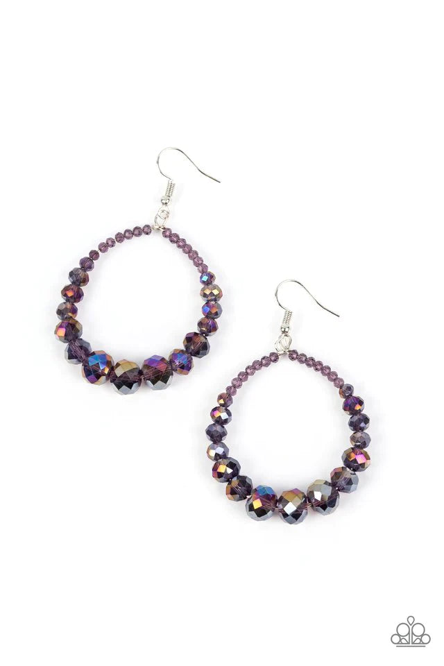 Paparazzi Accessories Astral Aesthetic - Purple Featuring a flashy faceted finish, purple gems with a kaleidoscopic overlay gradually increase in size as they glide along a wire hoop, resulting in a stellar teardrop. Earring attaches to a standard fishhoo