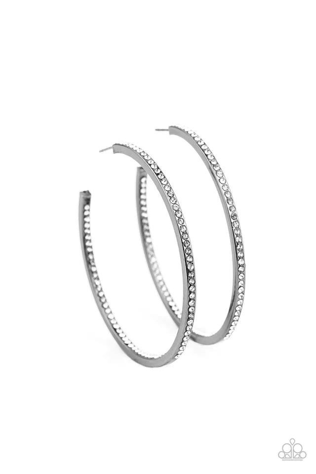 Paparazzi Accessories Marquee Magic - Black Sections of dainty white rhinestones are encrusted along the front and inside of a glistening gunmetal hoop for an unexpected hint of shimmer. Earring attaches to a standard post fitting. Hoop measures approxima
