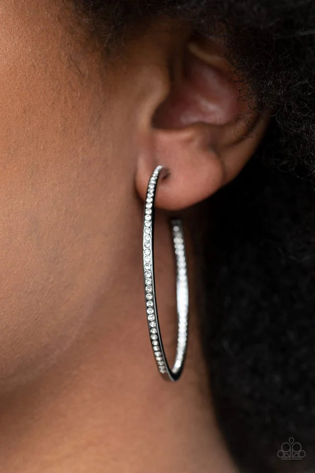 Paparazzi Accessories Marquee Magic - Black Sections of dainty white rhinestones are encrusted along the front and inside of a glistening gunmetal hoop for an unexpected hint of shimmer. Earring attaches to a standard post fitting. Hoop measures approxima