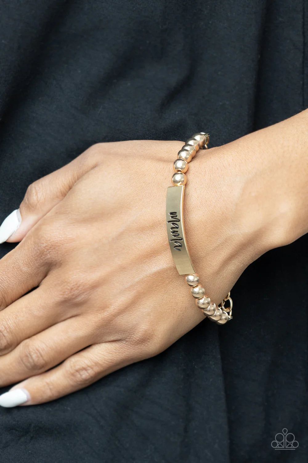 Paparazzi Accessories Mom Squad - Gold Stamped in the word, "Mama," a curved gold plate attaches to strands of gold beads threaded along invisible wire around the wrist, creating a sentimental centerpiece. Features an adjustable clasp closure. Sold as one