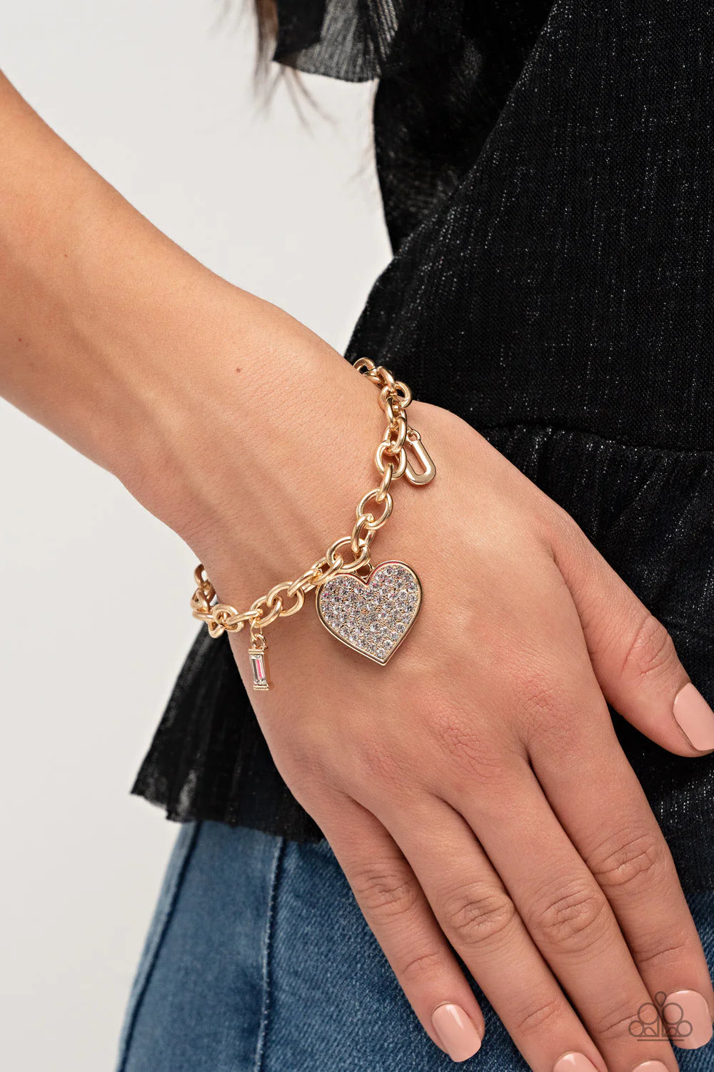 Paparazzi Accessories Declaration of Love - Gold A gold heart frame brimming with brilliant dainty white rhinestones dangles from a chunky gold chain between two gold letter charms. The letter "I" is created from an emerald cut rhinestone framed in gold a