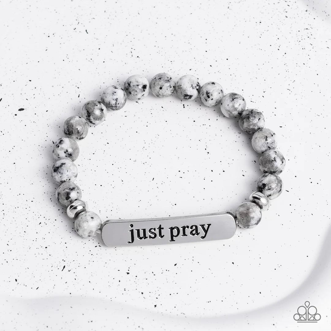 Paparazzi Accessories Just Pray - Silver Smooth, gray speckled stones are stretched across the wrist on an elastic stretchy band, with accents of silver beads sprinkled in. Meeting in the center of the stony display, a curved rectangular bar is stamped wi