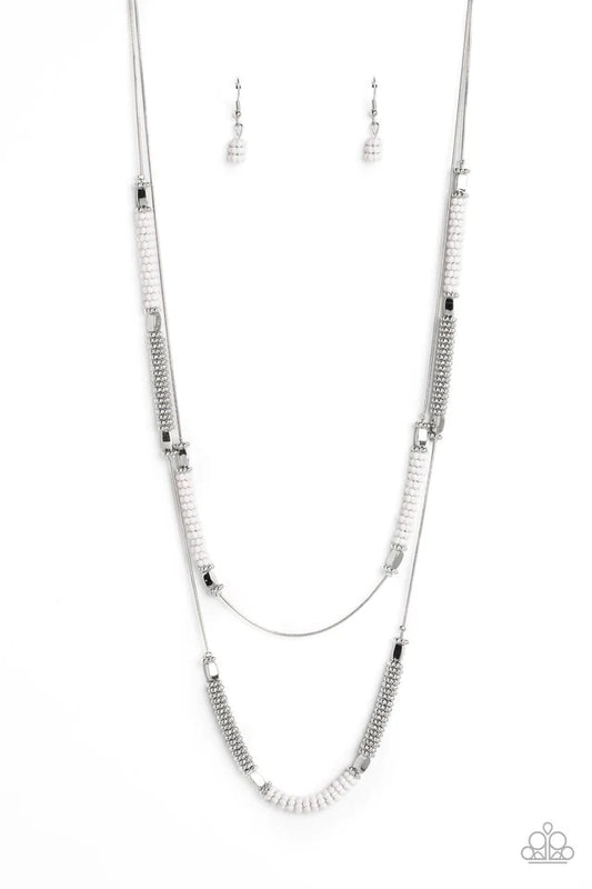 Paparazzi Accessories Caviar Chic - White Featuring a layered display, two elongated silver snake chains dance down the neckline. Sections of shiny silver flower beads, capped by high sheen silver accents, are interspersed with stacks of white and silver