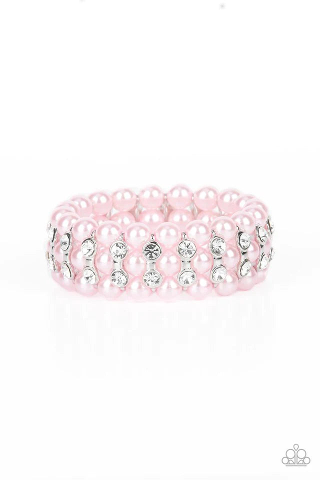 Paparazzi Accessories Eiffel Tower Elegance - Pink Stacked rows of bubbly pink pearls alternate with white rhinestone encrusted silver frames along stretchy bands, adding a timeless twist to the traditional pearl palette. Jewelry