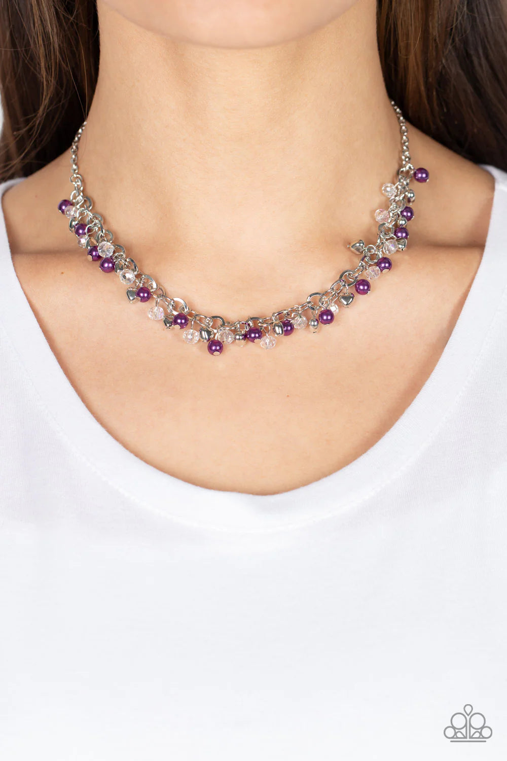Paparazzi Accessories Soft-Hearted Shimmer - Purple A dainty collection of purple pearls, white crystal-like accents, and silver heart beads delicately clusters along a dainty silver chain, creating a flirtatious fringe below the collar. Features an adjus
