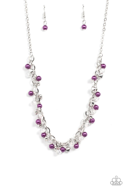 Paparazzi Accessories Soft-Hearted Shimmer - Purple A dainty collection of purple pearls, white crystal-like accents, and silver heart beads delicately clusters along a dainty silver chain, creating a flirtatious fringe below the collar. Features an adjus