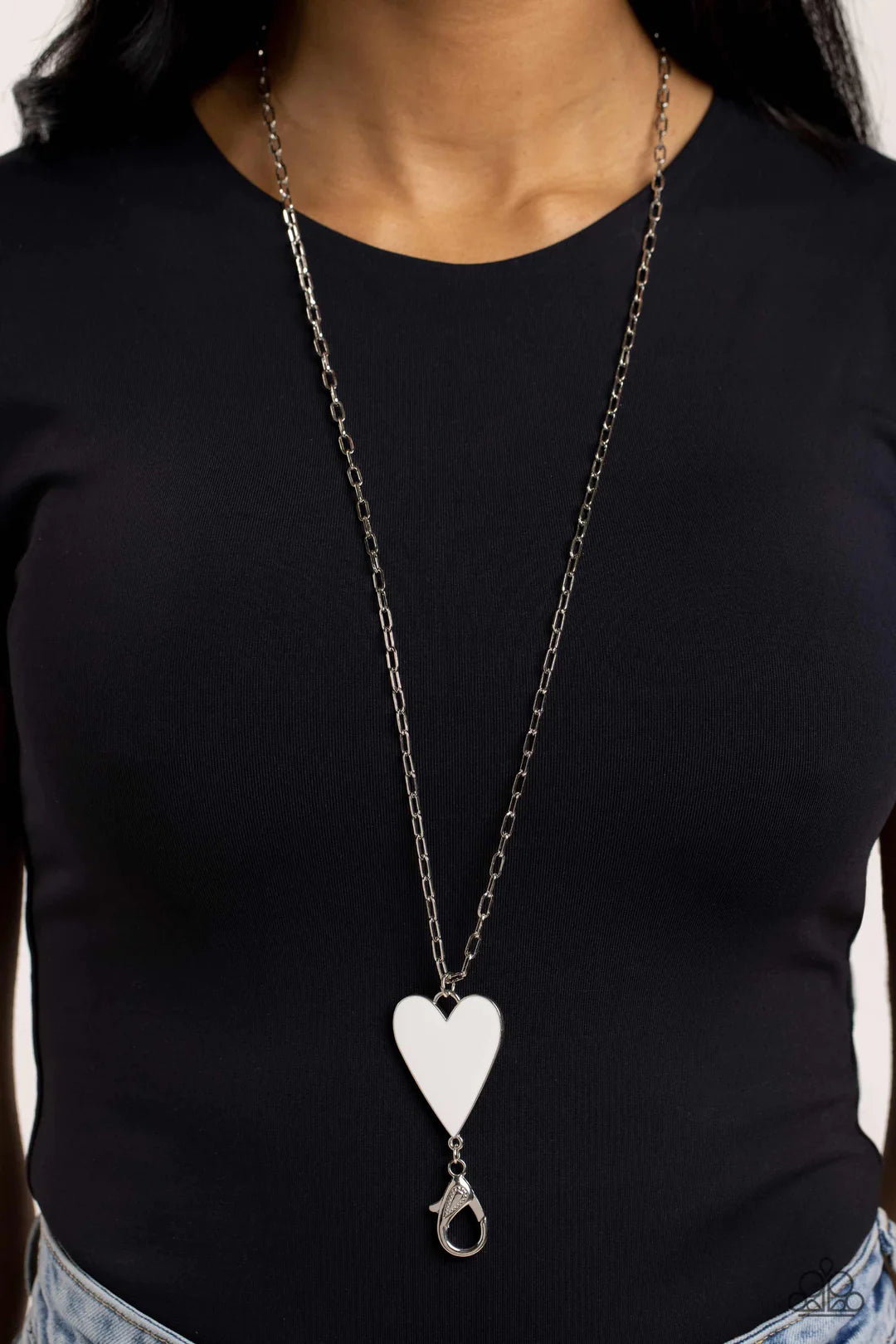 Paparazzi Accessories Subtle Soulmate - White Shiny silver oval links coalesce down the neck on an elongated chain, meeting a white heart pendant wrapped in an understated silver frame for a colorfully romantic finish. A lobster clasp hangs from the botto