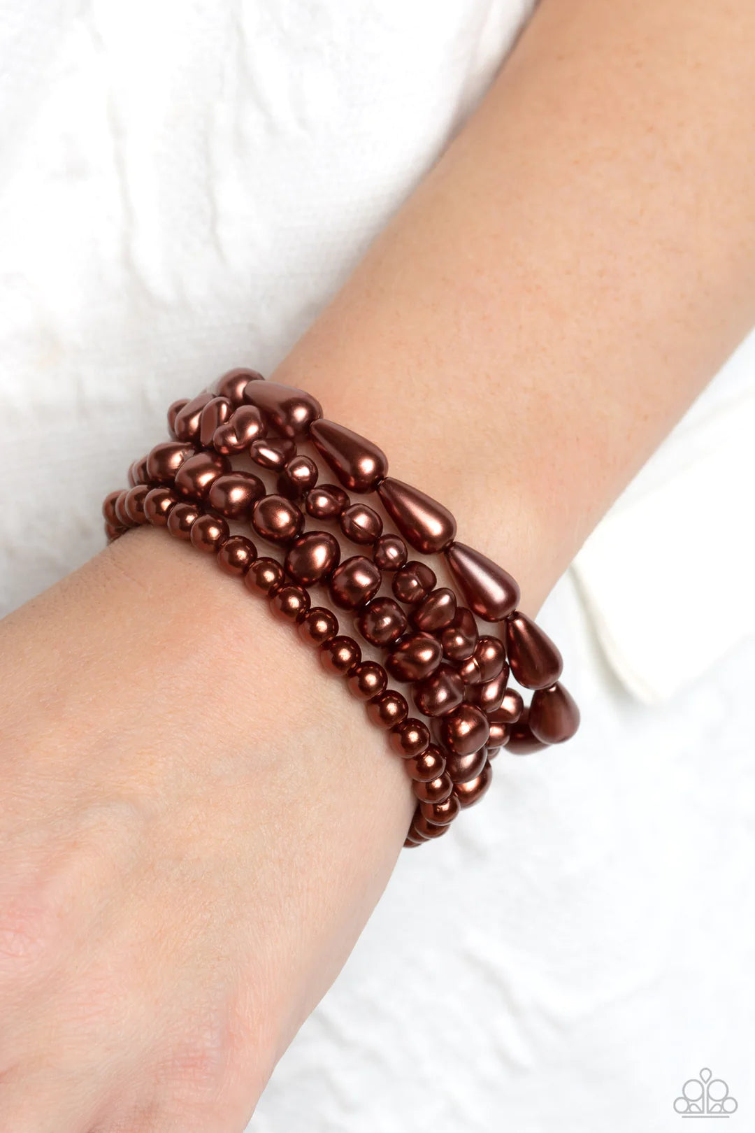 Paparazzi Accessories Gossip Pearl - Brown An abstract collection of brown baroque pearls coalesces around the wrist in four layers on elastic stretchy bands for a fashionably, refined stack. Sold as one set of four bracelets. Jewelry