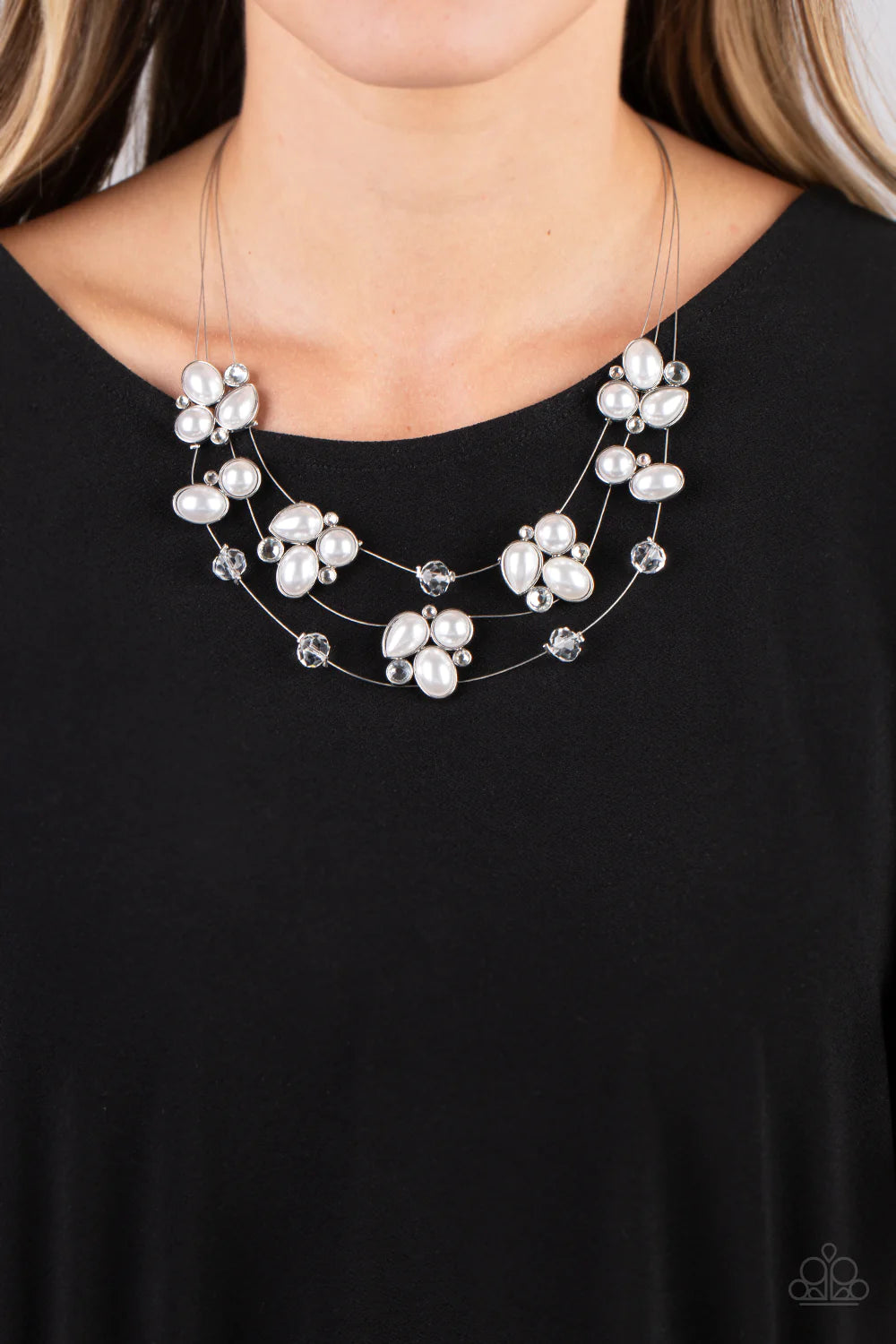 Paparazzi Accessories Snow Angels - White Strung along a trio of delicate silver wires, an ethereal collection of white crystal-like gems, clear faceted beads, and timeless pearls are pressed into teardrop, oval, and circular frames as they cluster along