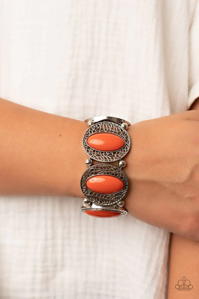 Paparazzi Accessories Eastern Escapade - Orange Bordered in airy stenciled frames, burnt orange beaded silver frames join pairs of silver beads along stretchy bands along the wrist for a seasonal pop of color. Jewelry