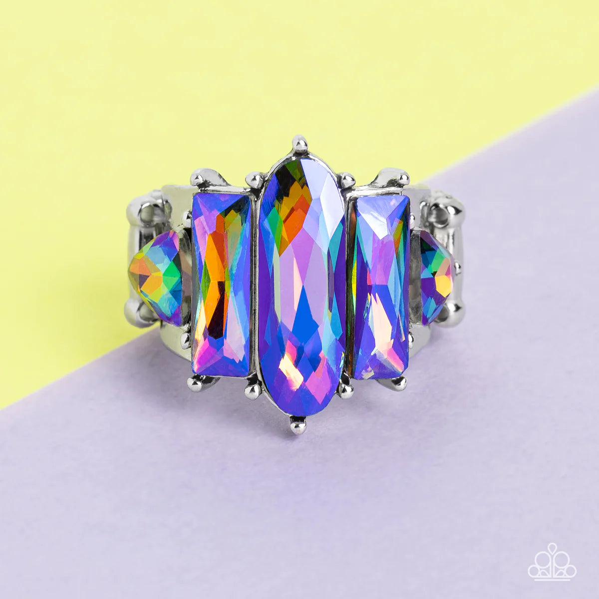 Paparazzi Accessories Iridescently Interstellar - Multi Featuring a stellar UV finish, an iridescent collection of triangular, emerald, and oval cut rhinestones are encrusted across the center of a thick silver band for an out-of-this-world fashion. Featu