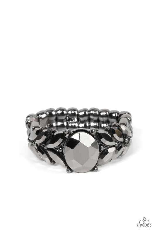 Paparazzi Accessories Smooth Smolder - Black Pairs of marquise cut hematite rhinestones fan out from an oversized hematite rhinestone, creating glitzy leafy accents across the front of a dainty and studded gunmetal band. Features a dainty stretchy band fo