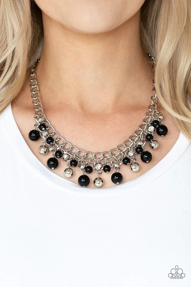 Paparazzi Accessories The Bride To Bead - Black Varying in size, a collection of polished black and shiny silver beads swing from the bottom of interlocking silver chains below the collar. A row of glassy white rhinestones are sprinkled along the colorful