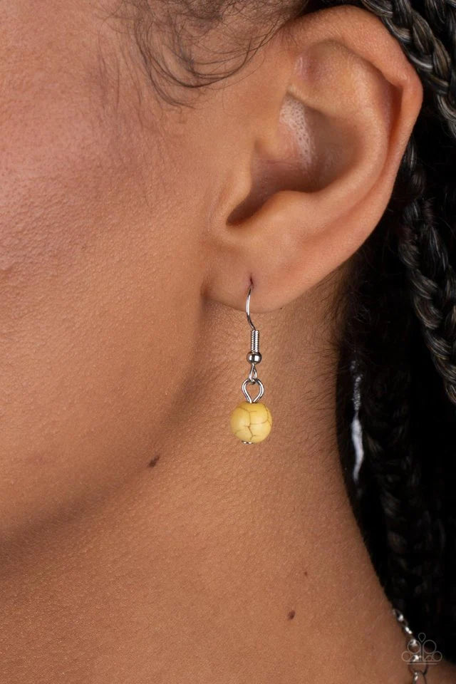 Paparazzi Accessories Wild Prairies - Yellow A dainty yellow stone is pressed into the center of a silver disc stamped in a whimsical floral motif, resulting in an earthy pop of color at the bottom of an extended silver chain. Features an adjustable clasp