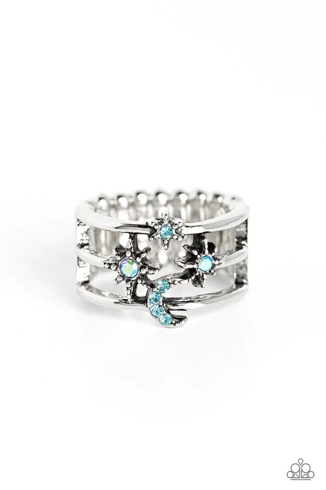 Paparazzi Accessories Fly Me To The Stars - Blue Featuring blue and iridescent rhinestones, three-dimensional stars, and a crescent moon dot across three sleek silver bands that meet in the center of the finger, creating a sparkling out-of-this-world cent
