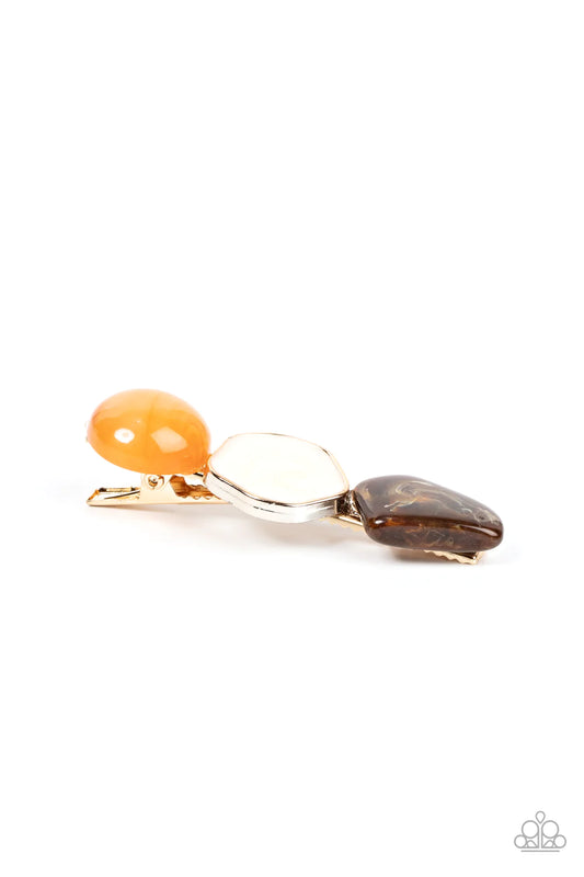 Paparazzi Accessories Quarry Couture - Orange Varying in shape, faux orange and brown stone accents flank a gold frame swirling with glossy white paint, resulting in a seasonal frame. Features a standard hair clip on the back. Sold as one individual hair