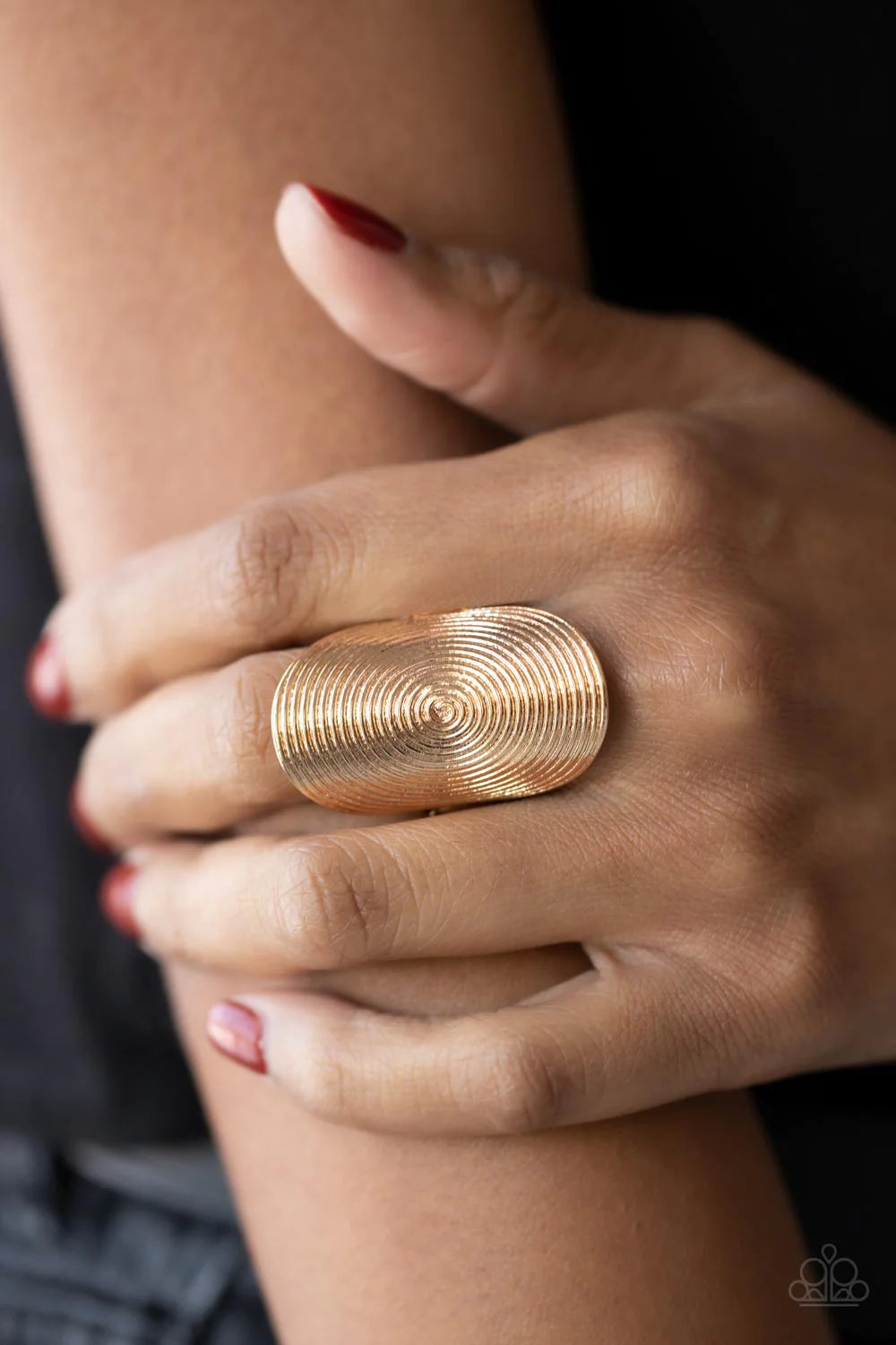 Paparazzi Accessories Urban Labyrinth - Gold A dizzying swirl is embossed across the front of an oversized gold oval frame, creating an entrancing centerpiece atop the finger. Features a stretchy band for a flexible fit. Sold as one individual ring. Jewel
