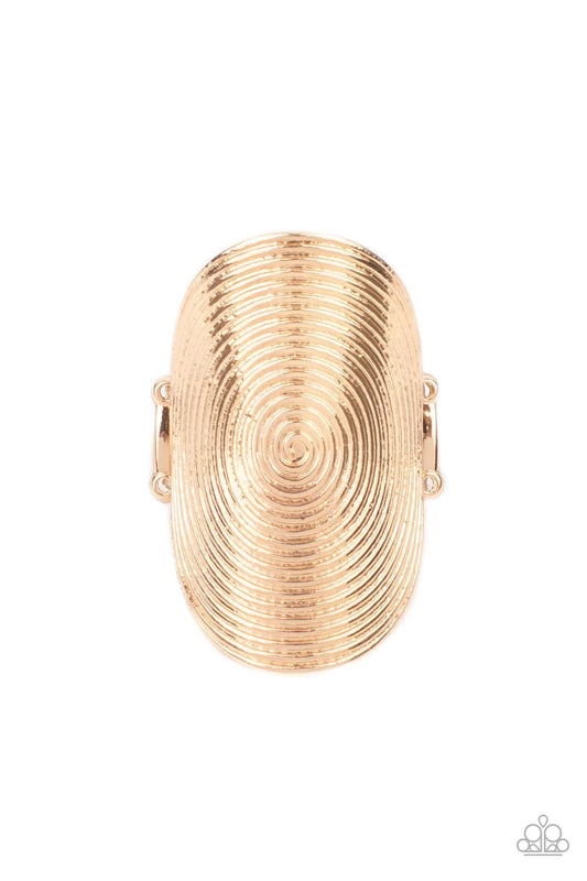 Paparazzi Accessories Urban Labyrinth - Gold A dizzying swirl is embossed across the front of an oversized gold oval frame, creating an entrancing centerpiece atop the finger. Features a stretchy band for a flexible fit. Sold as one individual ring. Jewel