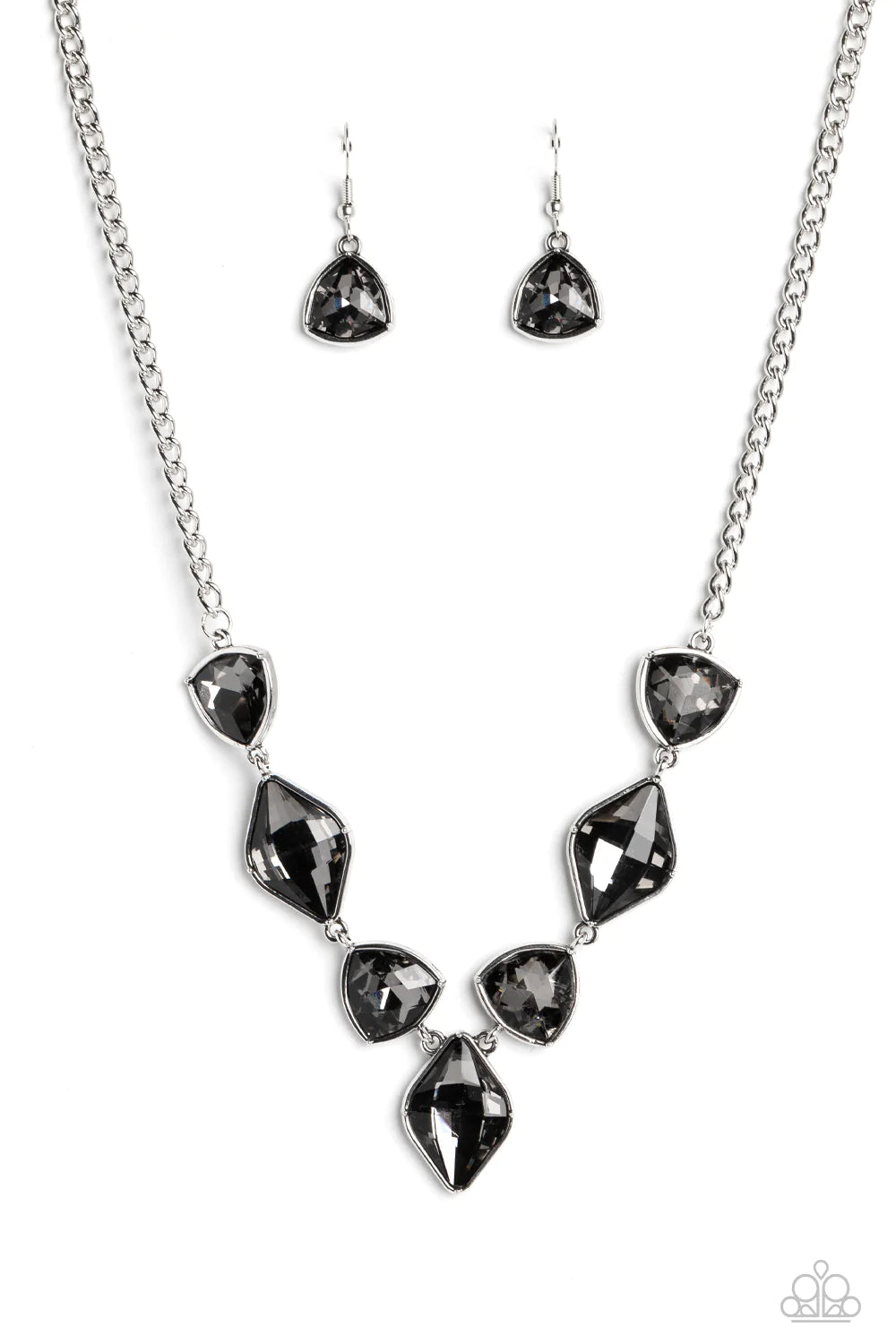 Paparazzi Accessories Glittering Geometric - Silver Set in silver frames, glittering geometric shapes with a smoky shimmer delicately coalesce around the collar for a statement piece. Features an adjustable clasp closure. Sold as one individual necklace.