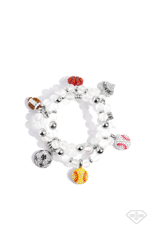 Paparazzi Accessories Sports Fan - Multi A mismatched assortment of various rhinestone-encrusted sports balls and a "DANCE"-stamped rhinestone heart, silver accents, and white glass-like beads are threaded along stretchy bands around the wrist, creating a