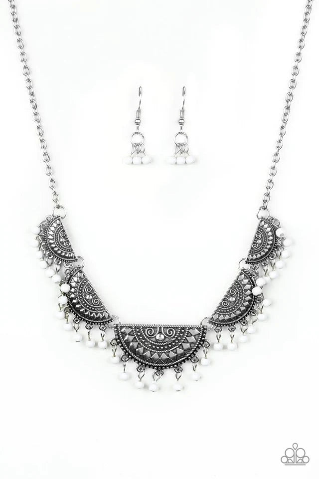 Paparazzi Accessories Boho Baby - White Embossed in tribal inspired patterns, silver half-moon frames link below the collar. Dainty white beads swing from the bottoms of the ornate frames, creating a flirtatious fringe. Features an adjustable clasp closur