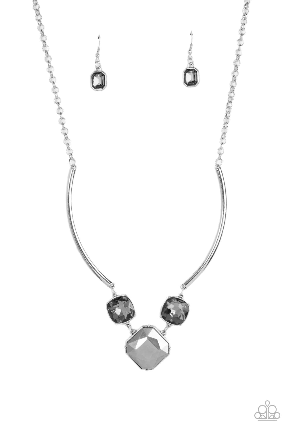 Paparazzi Accessories Divine IRIDESCENCE - Silver An oversized collection of radiant cut smoky and hematite gems delicately link at the bottom of two curved silver rods. Attached to shiny silver chains, the glamorously glitzy display sparkles below the co