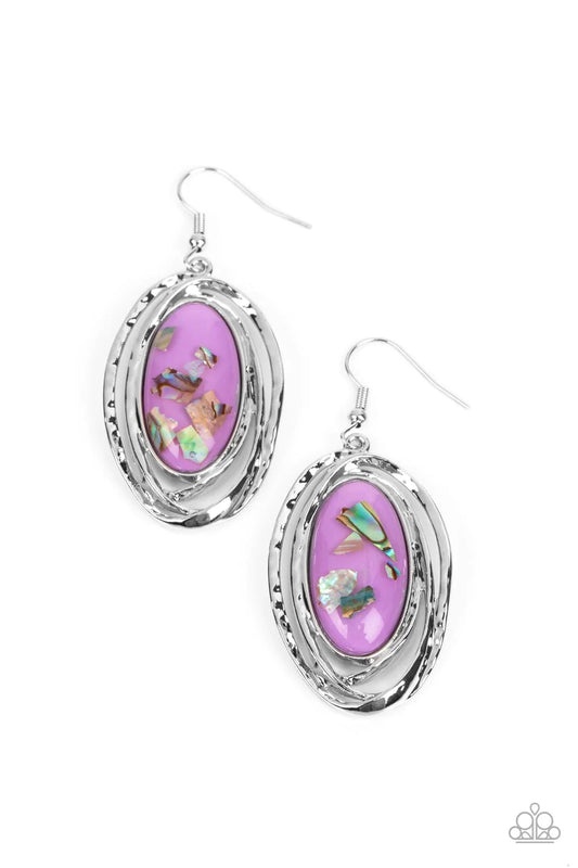 Paparazzi Accessories Ocean Floor Oracle - Purple Flecks of iridescent shell shimmer against a background of purple, creating an oblong oval centerpiece. Ripples of textured silver radiate from the shimmery focal point, encasing the design in asymmetrical