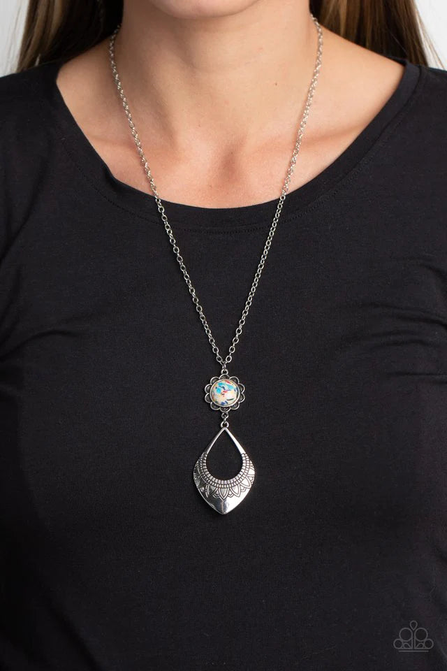 Paparazzi Accessories Stone Toll - Yellow Dangling from an elongated, silver link chain, two whimsical, interconnected shapes coalesce down the chest. An oversized pale yellow stone dotted with multicolored specks, is wrapped in a silver floral frame that