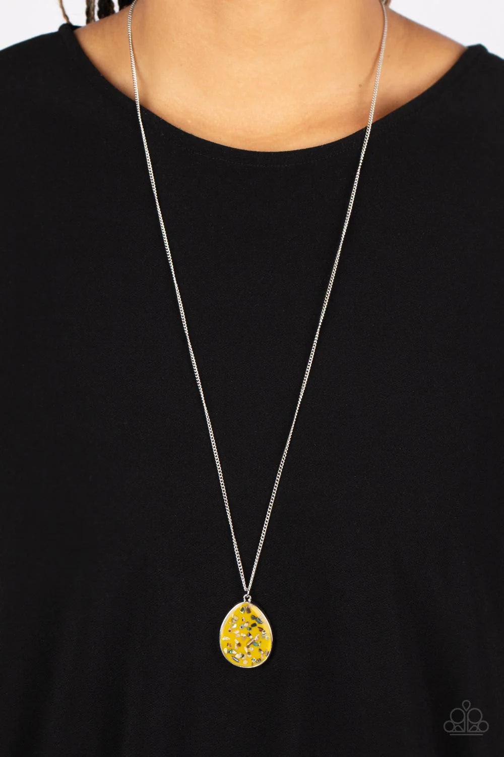 Paparazzi Accessories Shimmering Seafloors - Yellow Featuring a shell-like iridescence, shimmery flecks are sprinkled along a mustard yellow backdrop inside of a glassy casing. The colorful teardrop swings from the bottom of an extended silver chain, crea