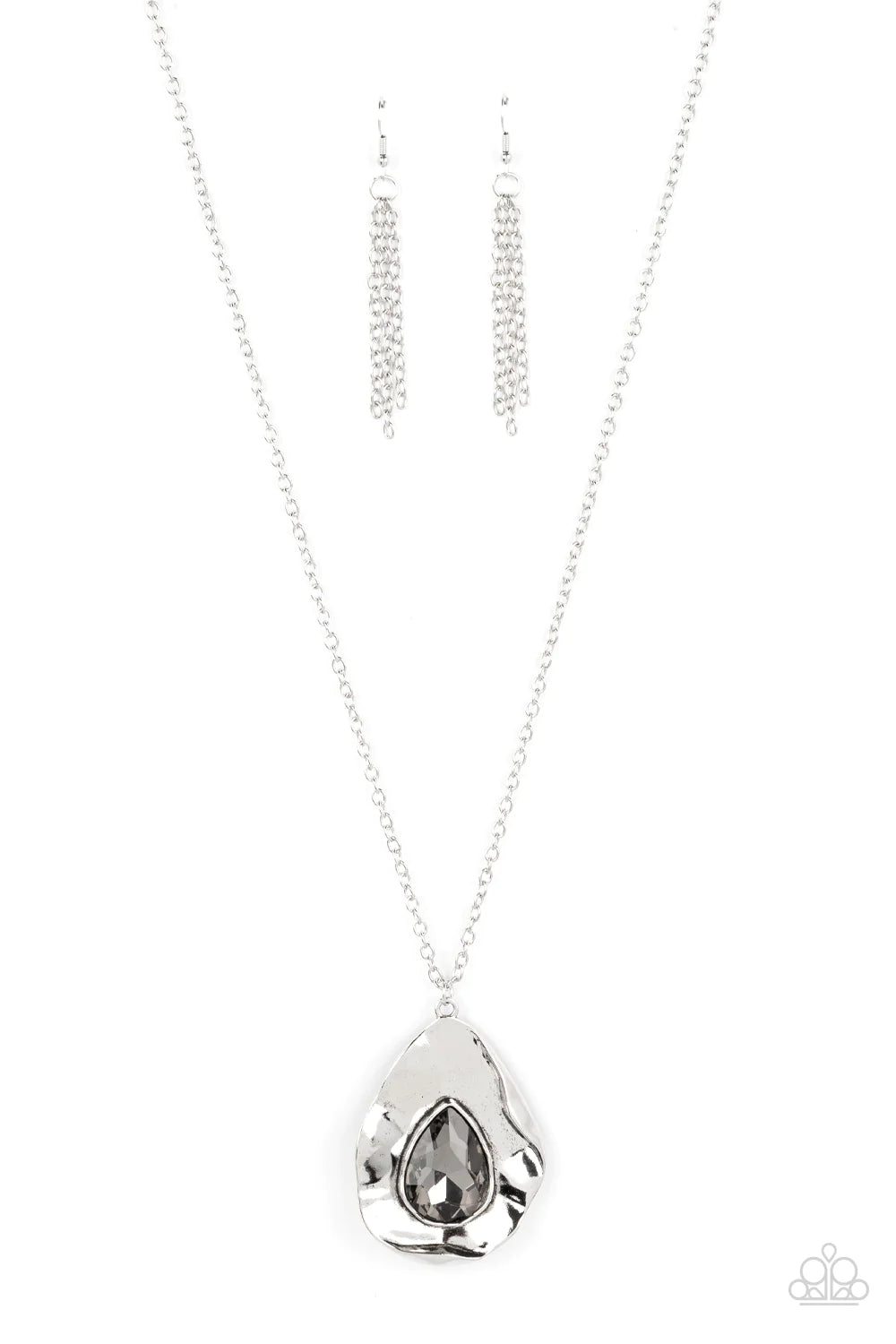 Paparazzi Accessories Surrealist Sparkle - Silver A warped silver frame gently folds around an oversized smoky teardrop gem center, resulting in a gritty yet glamorous pendant at the bottom of a lengthened silver chain. Features an adjustable clasp closur