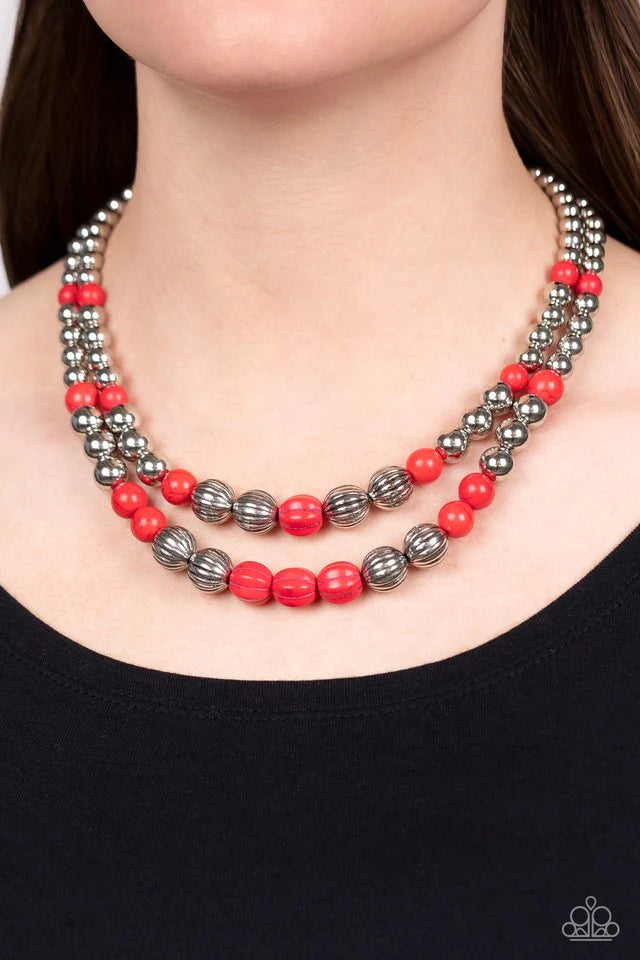 Paparazzi Accessories Country Road Trip - Red Gradually increasing in size, an earthy series of shiny silver beads, fiery red stones, and faux red stone accents are threaded along invisible wires below the collar, resulting in a rustic layered look. Featu