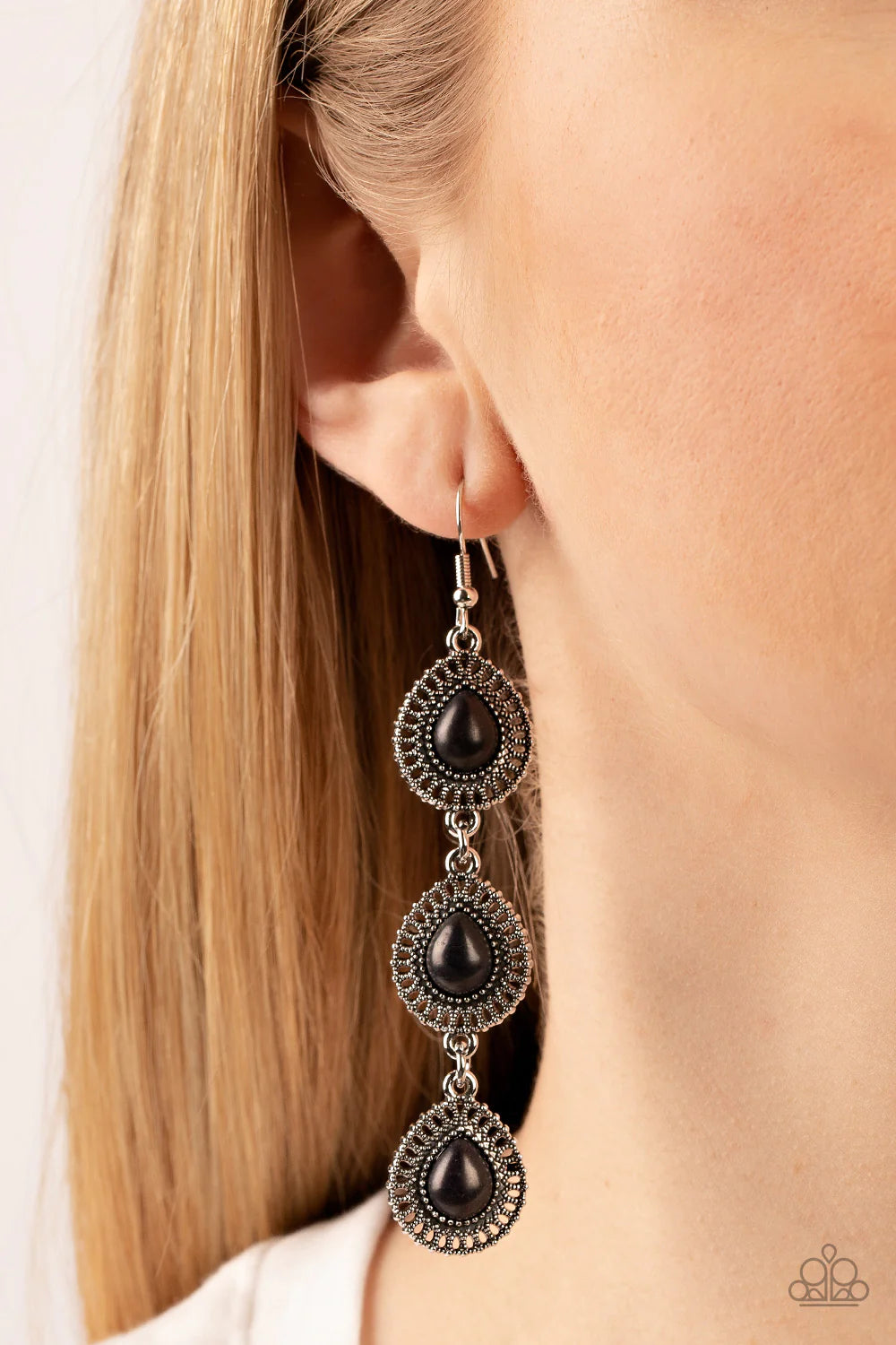 Paparazzi Accessories Desertscape Dweller - Black A trio of black stone teardrops are pressed into the centers of studded silver frames radiating with dizzying textures. The ornate frames delicately link into an extended lure for an exaggerated earthy loo