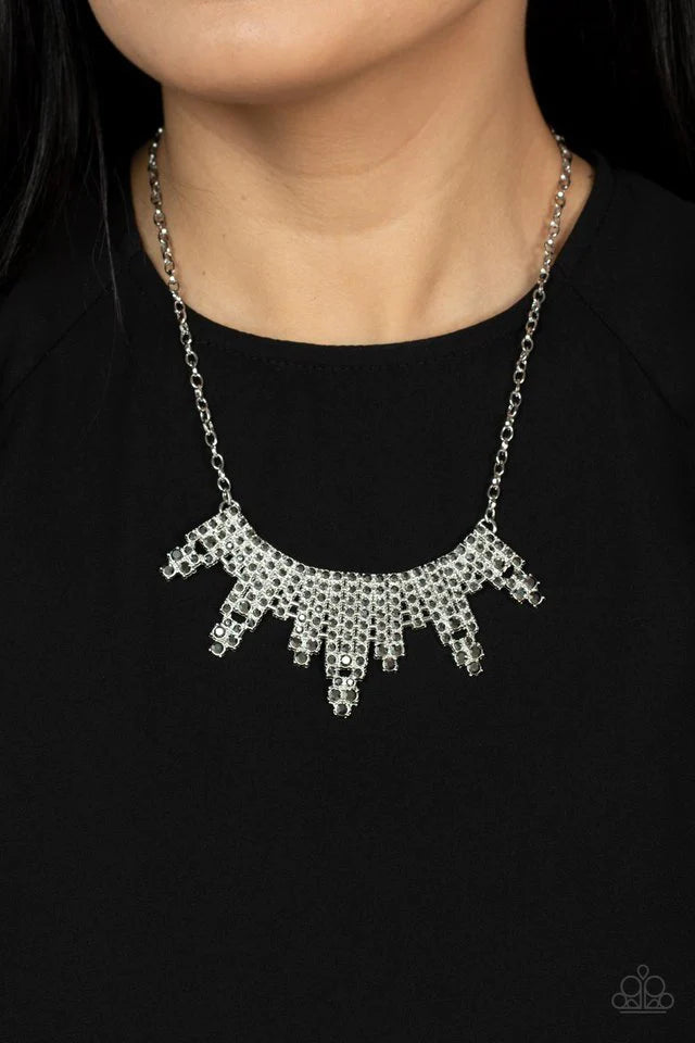 Paparazzi Accessories Skyscraping Sparkle - Silver Featuring studded silver fittings, glitzy rows of sparkly hematite rhinestones stack into gritty towers that curve below the collar for an edgy effect. Features an adjustable clasp closure. Sold as one in