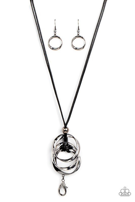 Paparazzi Accessories Harmonious Hardware - Black *Lanyard Infused with a glistening gunmetal bead, curved silver and gunmetal rings are knotted in place at the bottom of a shiny black cord for an intense industrial display. A lobster clasp hangs from the
