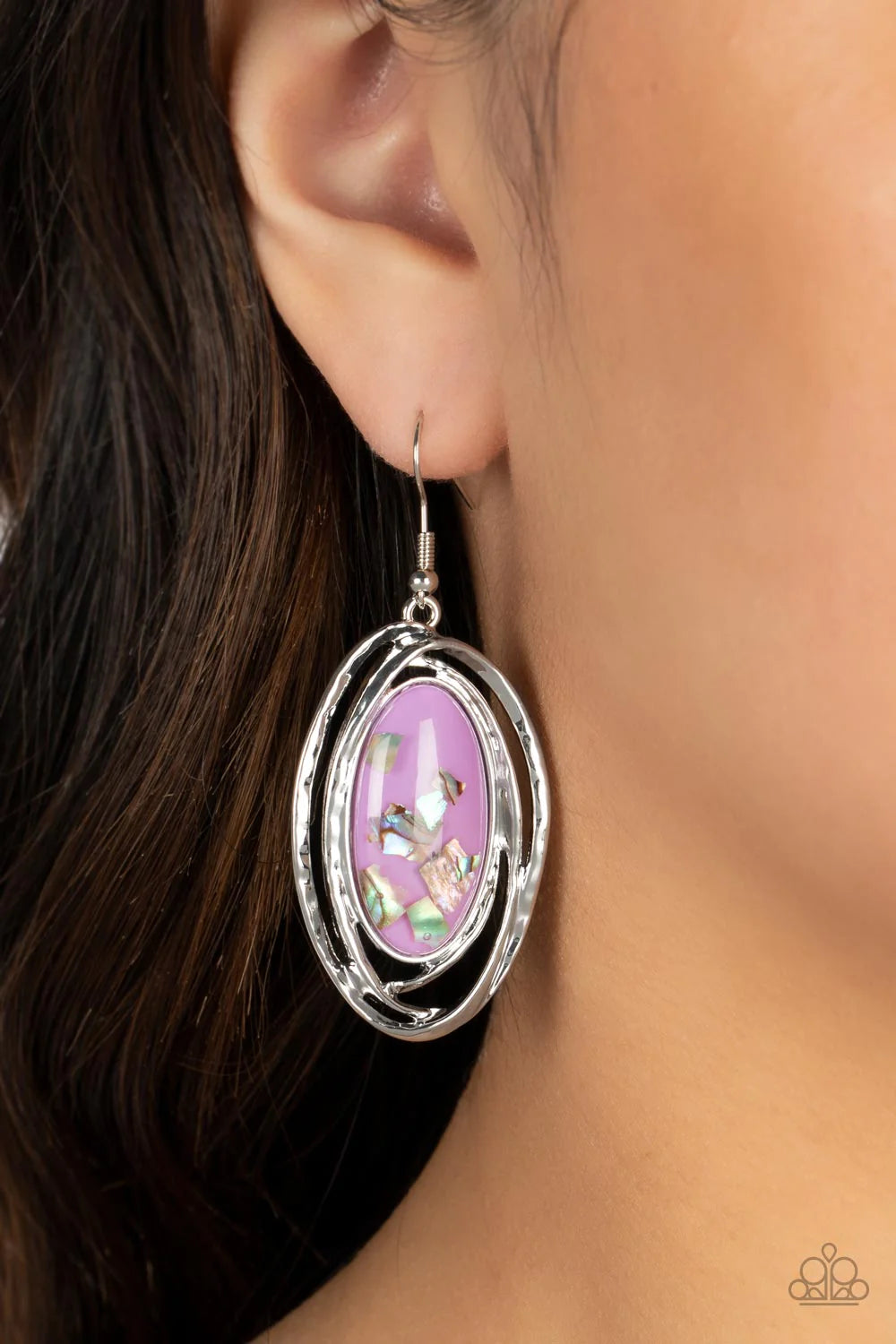 Paparazzi Accessories Ocean Floor Oracle - Purple Flecks of iridescent shell shimmer against a background of purple, creating an oblong oval centerpiece. Ripples of textured silver radiate from the shimmery focal point, encasing the design in asymmetrical