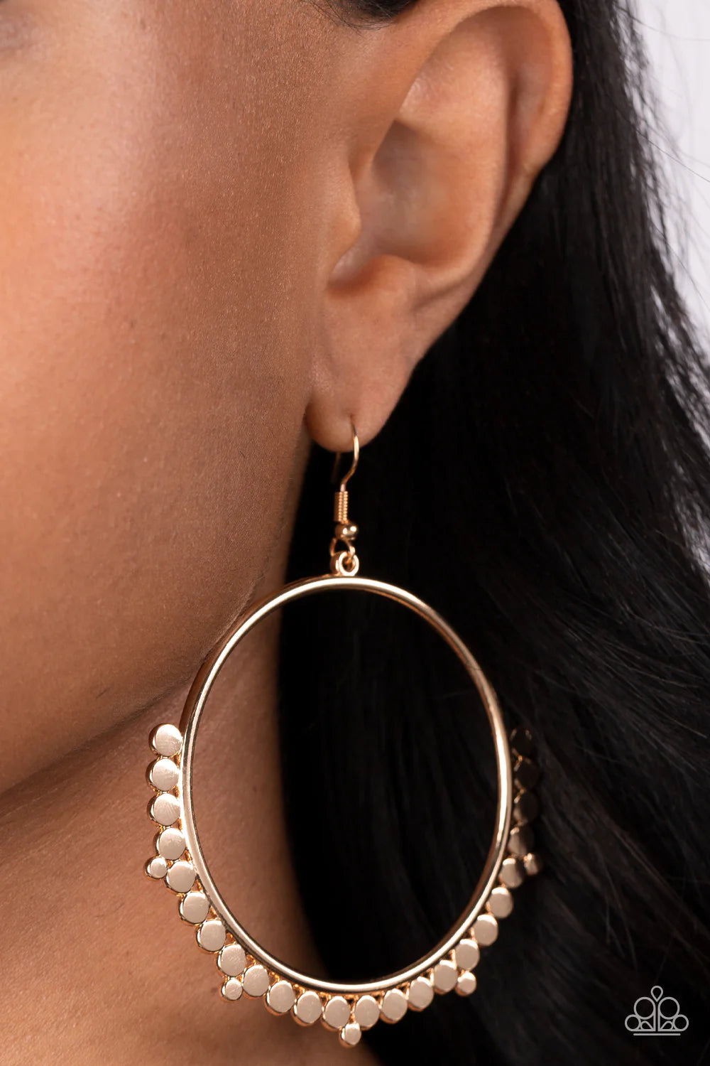 Paparazzi Accessories Ultra Untamable - Gold A collection of small, flat, gold discs gather along the bottom edge of an oversized gold hoop, creating an irresistible metallic fringe. Earring attaches to a standard fishhook fitting. Sold as one pair of Pap