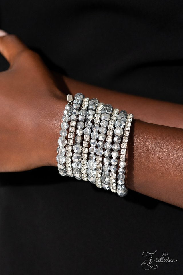 Paparazzi Accessories Ready For More - White A collection of faceted beads and sparkling white rhinestones is threaded along an invisible wire that coils around the wrist. Each flick of the wrist captures a different detail, mesmerizing onlookers with the