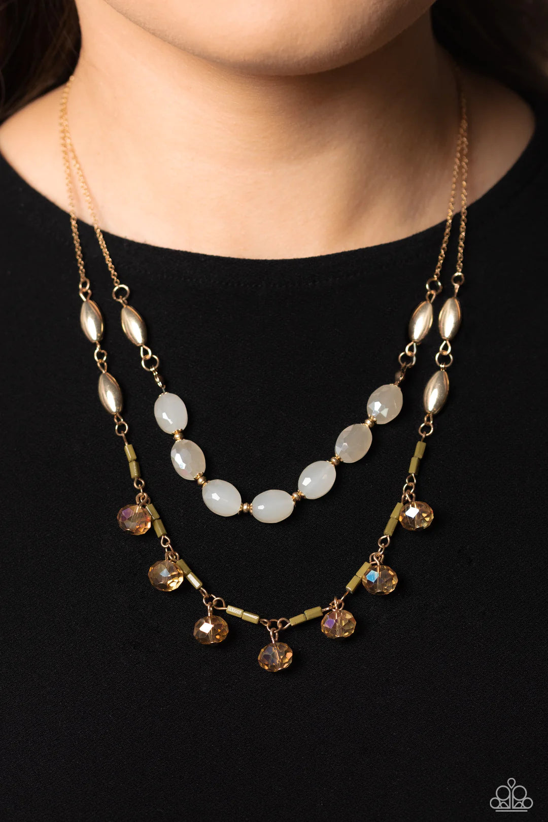 Paparazzi Accessories Sheen Season - Gold Two strands of dainty gold chain are adorned in a collection of white opaque beads, faceted glass beads, and gold accents, culminating in a layered design rich with vintage character. The glassy beads that swing a
