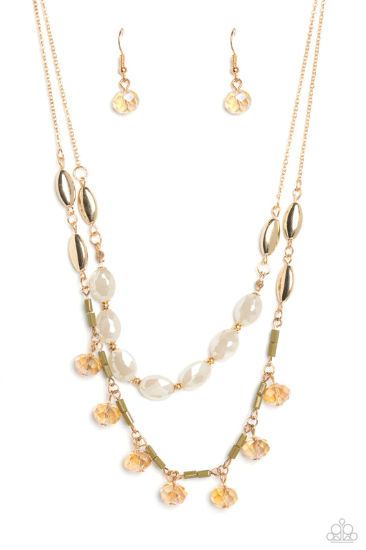Paparazzi Accessories Sheen Season - Gold Two strands of dainty gold chain are adorned in a collection of white opaque beads, faceted glass beads, and gold accents, culminating in a layered design rich with vintage character. The glassy beads that swing a