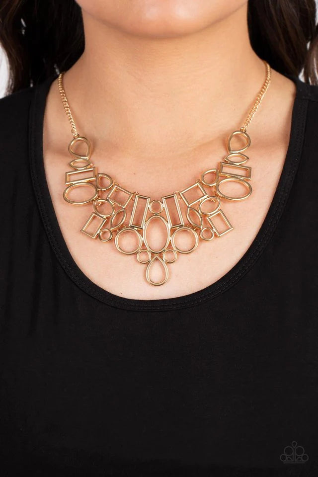 Paparazzi Accessories Geometric Grit - Gold A collection of open gold frames in a variety of geometric shapes collide to create a high sheen statement piece that adorns the collar. A teardrop drops from the center of the design, adding eye-catching dimens