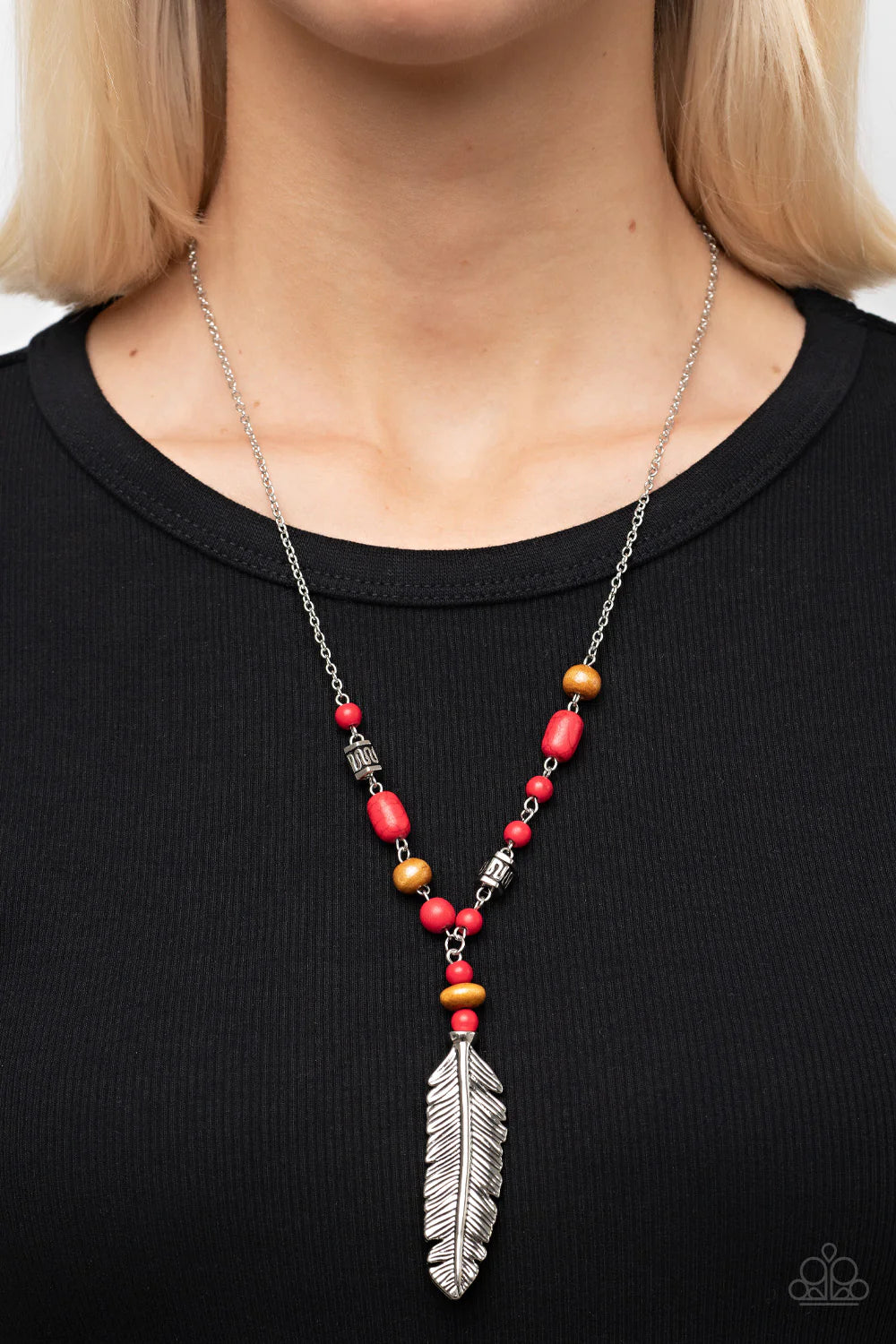 Paparazzi Accessories Watch Me Fly - Red A lifelike silver feather swings from the bottom of a dainty silver bead adorned in wooden beads, red stones, and textured silver accents, resulting in a free-spirited pendant. Features an adjustable clasp closure.