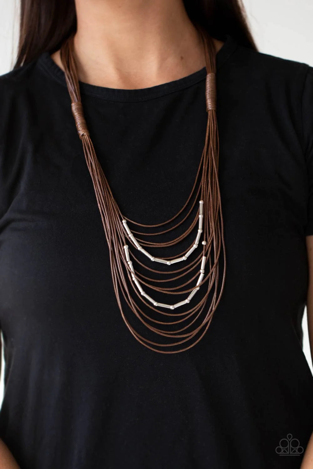 Paparazzi Accessories Nice CORD-ination - Brown Two rows of dainty silver beads and cylindrical rods are threaded along strands of shiny brown cording that has been knotted in place, creating edgy rows across the chest. Features an adjustable clasp closur