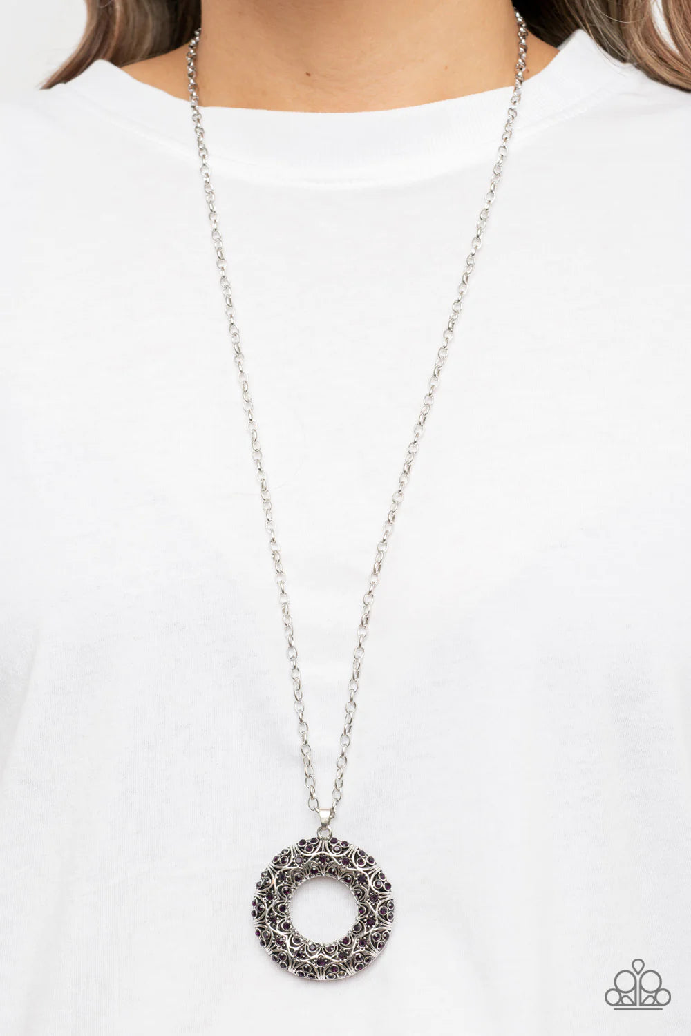 Paparazzi Accessories Wintry Wreath - Purple Dotted with glittering purple rhinestones and filled with frilly silver filigree accents, an oversized silver wreath sparkles from the bottom of an extended silver chain for a whimsical fashion. Features an adj