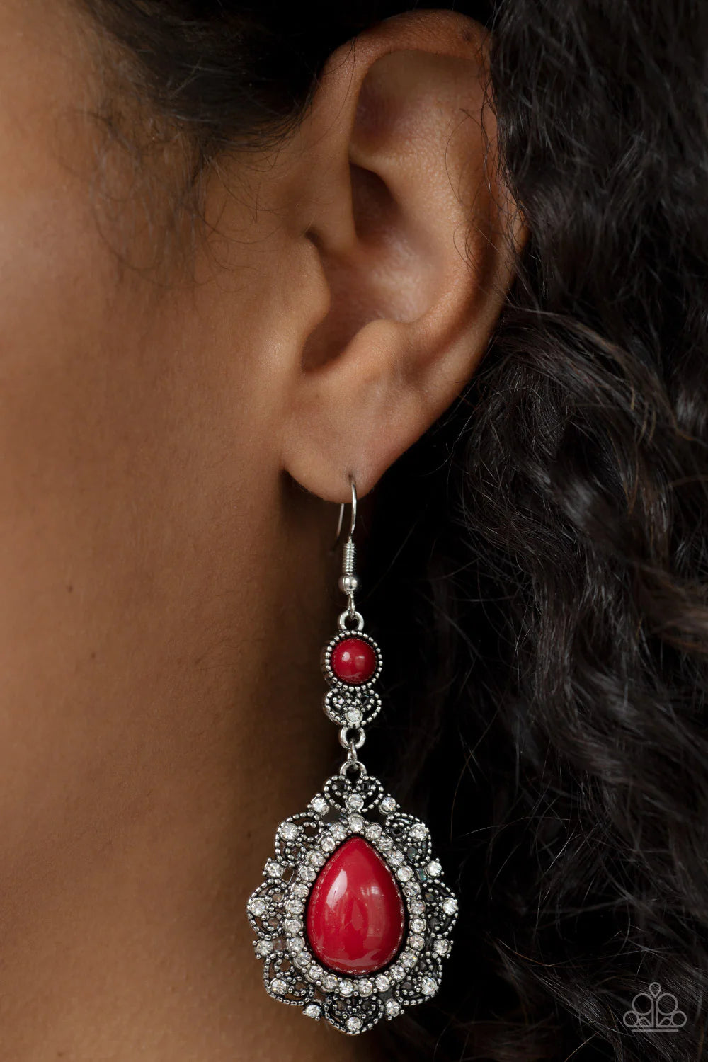 Paparazzi Accessories Palace Bribe - Red An oversized wine teardrop bead is bordered in a ring of glassy white rhinestones atop a silvery backdrop of a white rhinestone dotted heart motif. The charming frame swings from a matching beaded and rhinestone en