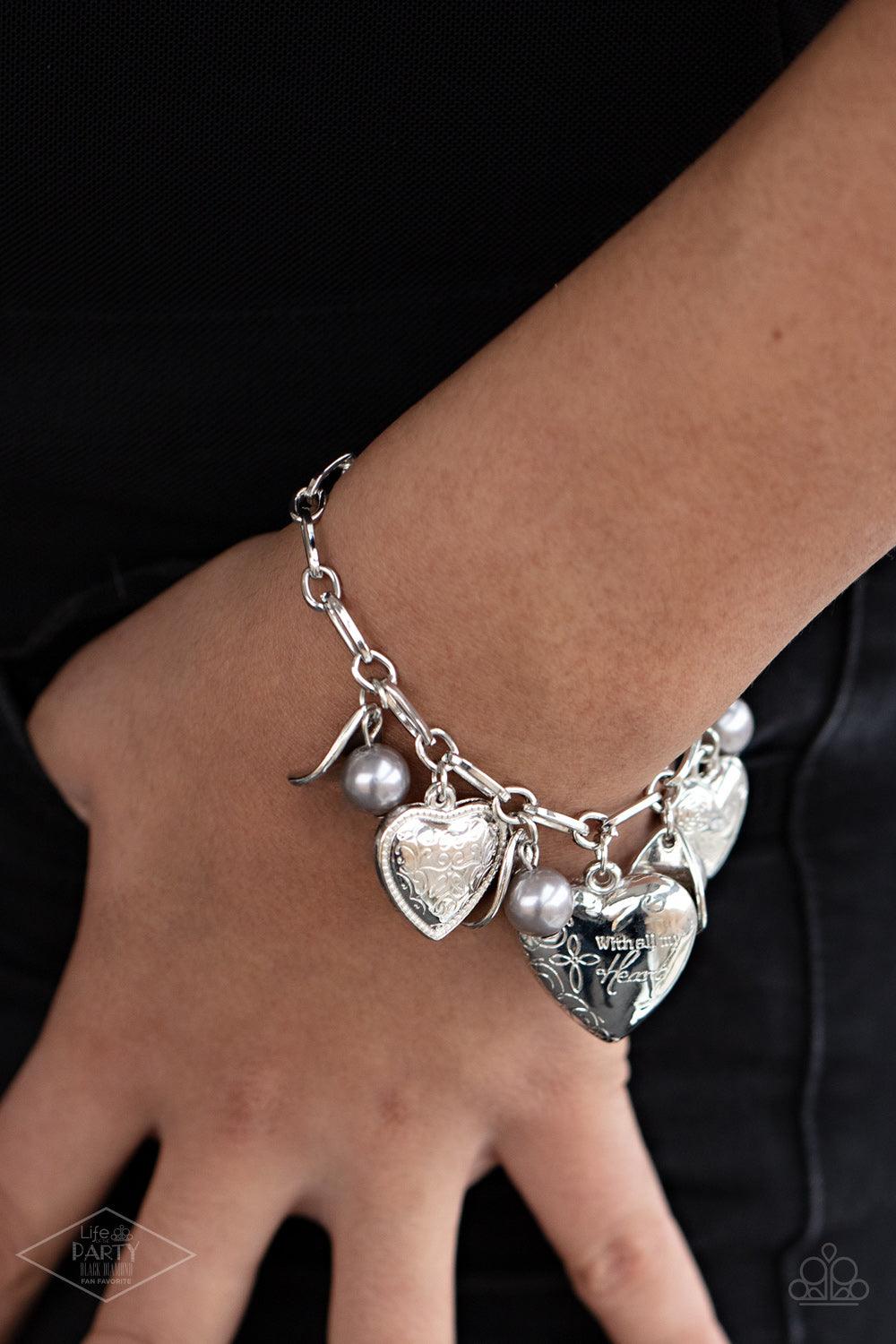 Paparazzi Accessories Love Will Find A Way -Silver Oversized silver links are adorned with curved silver discs, pearly gray beads, and an assortment of heart charms. One heart is etched with floral designs and the word, “Love,” another is swirled with fil