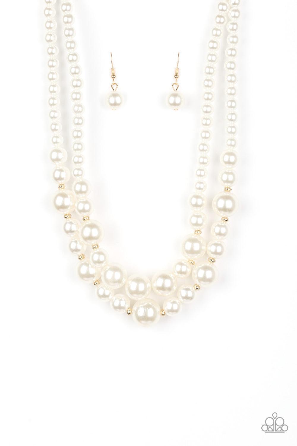 Paparazzi Accessories The More The Modest - Gold Infused with dainty gold accents, classic white pearls layer below the collar in a timeless fashion. Features an adjustable clasp closure. Sold as one individual necklace. Includes one pair of matching earr