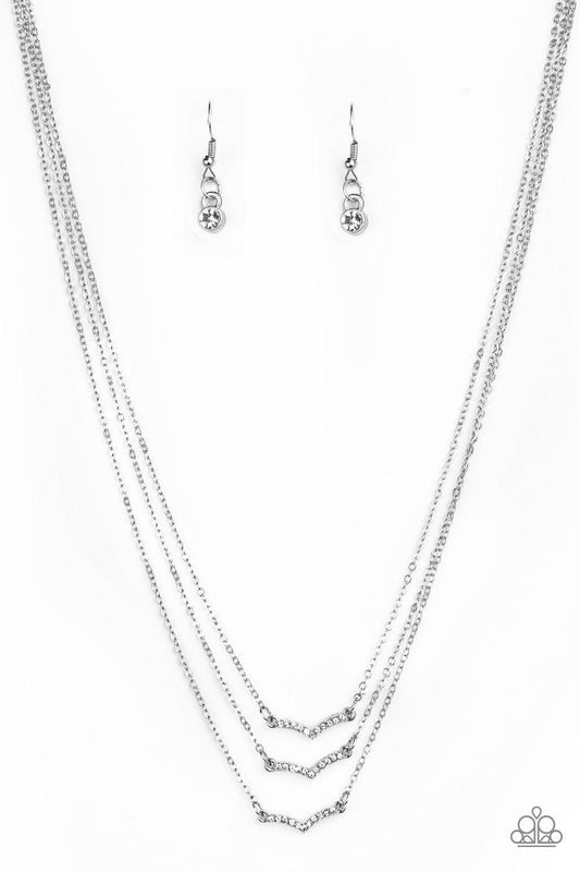 Paparazzi Accessories Pretty Petite - White Encrusted in glassy white rhinestones, three dainty silver frames layer below the collar for a classic look. Features an adjustable clasp closure. Sold as one individual necklace. Includes one pair of matching e
