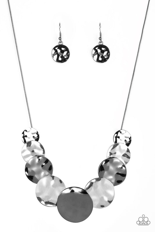 Paparazzi Accessories A Daring DISCovery - Black Gradually increasing in size near the center, hammered gunmetal and silver discs slide along a gunmetal wire chain below the collar for an edgy look. Features an adjustable clasp closure. Sold as one indivi